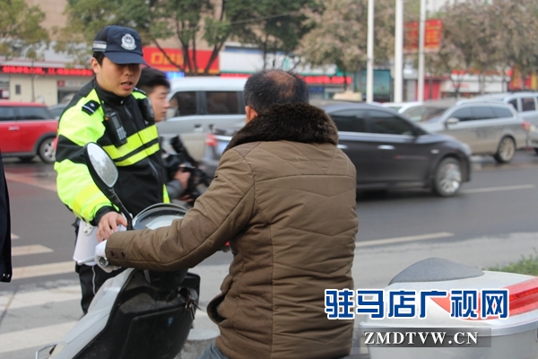 剛到路口，民警就攔住一位騎電動車闖紅燈的.JPG